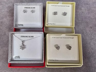 Matching set of star shaped earrings and necklace, both sterling silver with 1/20 cttw. Two more