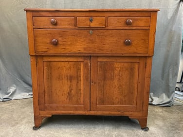 Circa 1840 cupboard with unusual four drawer configuration over two paneled doors. Cherry with