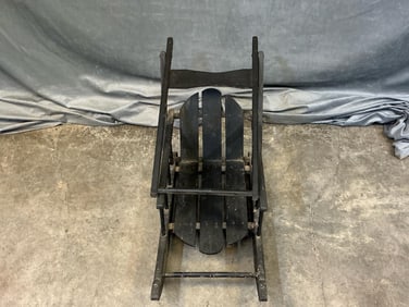 Early 20th century black painted child's sled with stuffed rabbit doll. Measures 12.25 inches length