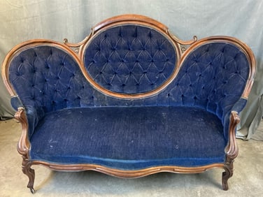 Late 19th century Victorian walnut carved blue upholstered couch with cabriole legs. Minor wear to