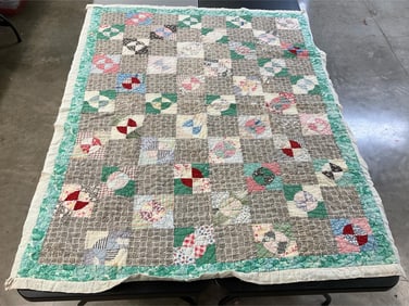Vintage hand quilted and machine stitched quilt. Faded and has some stains and tears. Measures 80