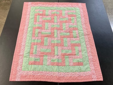 Modern baby girl quilt with a stair step pattern, machine stitched. In good condition. Measures 49