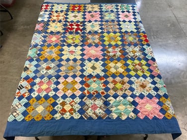 1960s-1970s hand tied, machine stitched quilt. Different sized blue border on all sides. A few holes