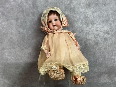 Early 1900s doll. Armand Marseilles German doll with original dress and bonnet. Porcelain face, arms
