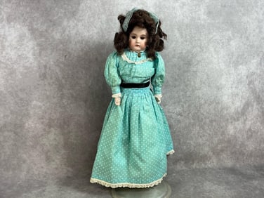 Early 1900s doll. A M Columbia doll with porcelain head and hands, and cloth body. Sleepy eyes and