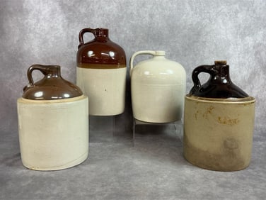 Four early to mid 1900s jugs. Salt glazed stoneware jugs around 1.5 to 2 gallon size. Some crazing,
