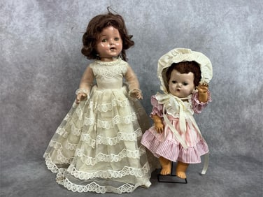Two early 1900s dolls. Composition dolls with sleepy eyes in original dress. Both have crazing, worn