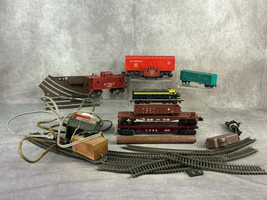 Mid 20th century assorted toy train pieces. Eight train cars including locomotive, two transformers,