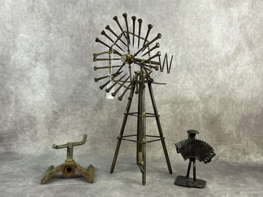 Vintage cast iron water sprinkler, and two contemporary sculptures - iron accordion player made out