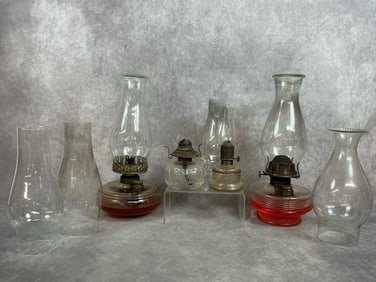 Four lamps and three extra globes from late 1800s to early 1900s. Two regular size oil lamps and