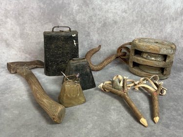 Double block and tackle pulley, three cowbells of varied sizes, a hatchet, and two homemade