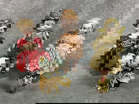 Five late 1800s to early 1900s dolls. Three small bisque dolls on stands, doll in orange flapper: Five late 1800s to early 1900s dolls. Three small bisque dolls on stands, doll in orange flapper dress is a Kestner. Includes bride and groom Kewpie dolls and miniature frozen Dutch boy. Dolls show we