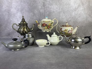 Lot of seven vintage teapots including two transferware porcelain, early 1900s pewter with wood