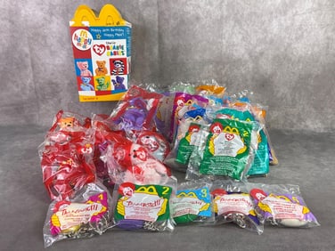 Lot of unopened McDonalds toys including TY beanie babies and Tamagotchi key ring toys. All in good