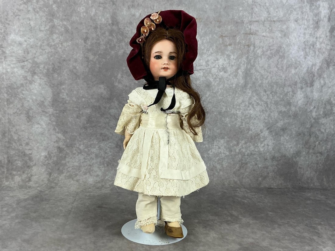 French Bisque Doll Made by S.F.B.J. Paris: 1910-1920 French bisque head doll with articulated composition body. Sleepy eyes with teeth. Marked on back of head "S.F.B.J. 301 Paris" - Societe Francaise de Fabrication de Bebe et Jouets (French so