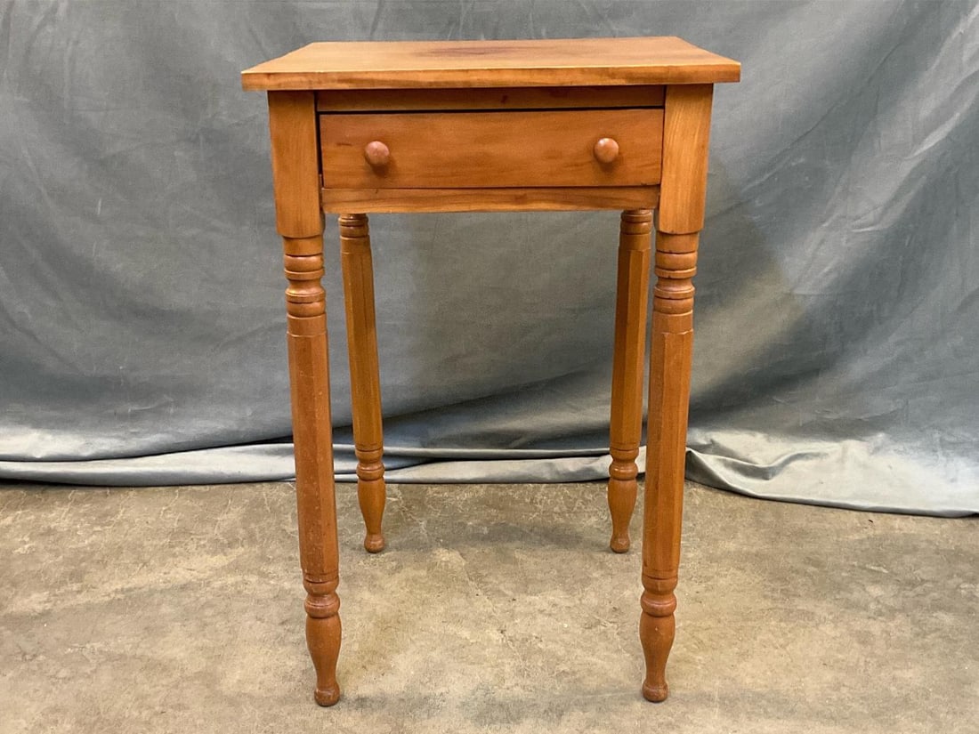 One Drawer Sheraton Style Table: 20th century bench made Sheraton style one drawer cherry table. Turned legs with dovetailed and doweled drawers. White pine secondary wood. Good condition. Measures 19 inches wide x 18.75 x 29.5 inche