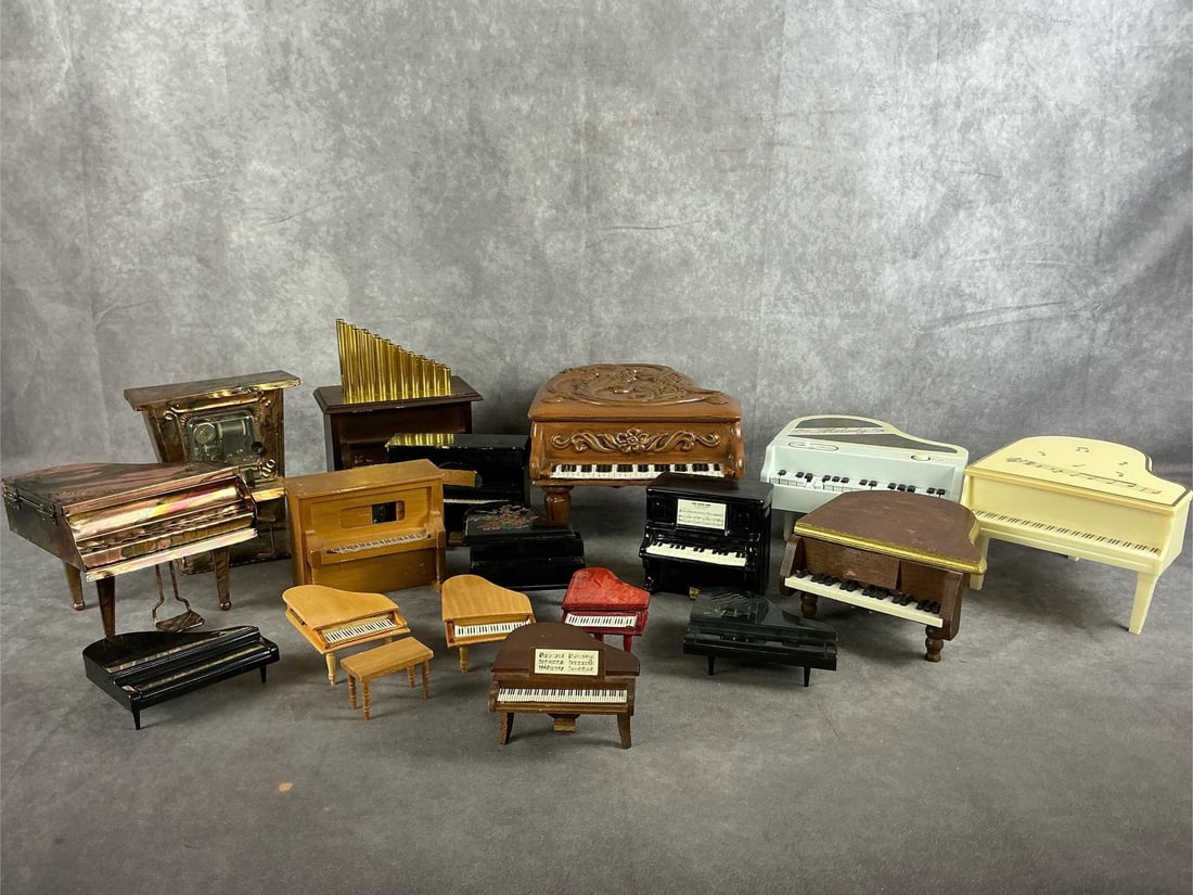 Collection of Pianos: Seventeen mid to late 1900s piano collectibles. Ceramic, tin, wood and plastic pianos. Trinket box, music box, coasters, and wind ups. Some wear and discoloration present. Fair to good condition. Larg