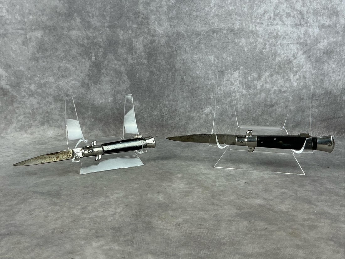 Italian Stileto Knives: Two Mid-20th century marked "G.C. Co. M Italy" stiletto knives. Guzman Cutlery. Plastic horn handles. Blades have staining and some scratches. Larger knife has good snap. Smaller knife has handle crac