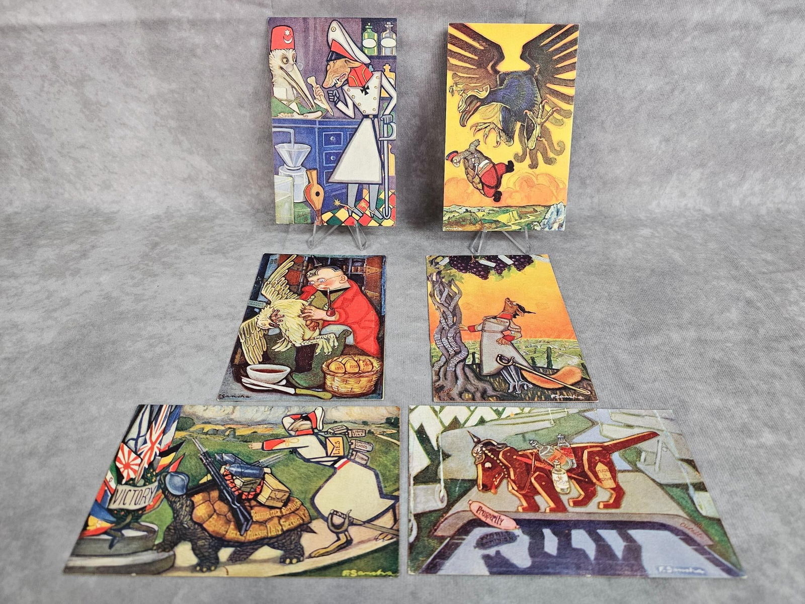Aesop's Fables Postcards: Set of six WWI era 1914-1918 postcards by Raphael Tuck, printed in England. Aesop's Fables political satirical cartoon postcards. Soft corners and some color bleed. Each one has a plastic protective s
