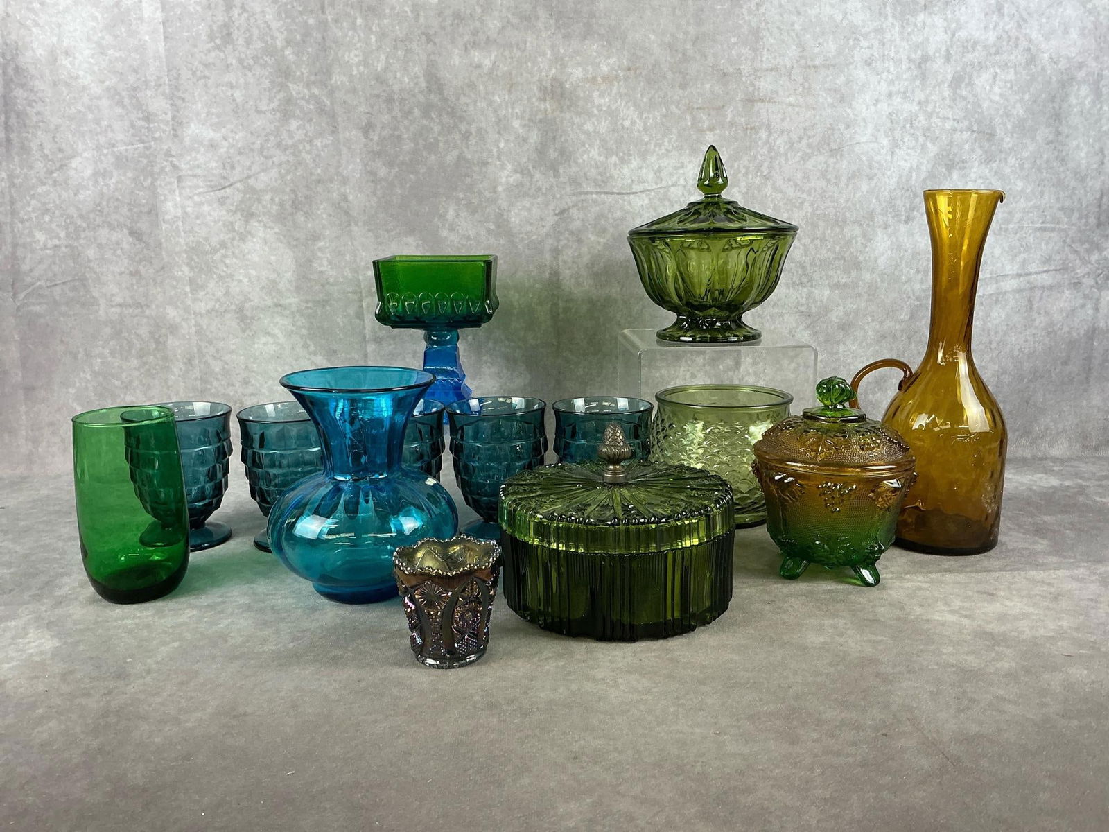 Imperial, Blenko, & More: Assorted 1950's - 1960's vintage glassware. One Imperial carnival glass toothpick holder. One Indiana Glass two sections lidded dish with brass acorn finial. One Blenko turquoise hand blown vase. One