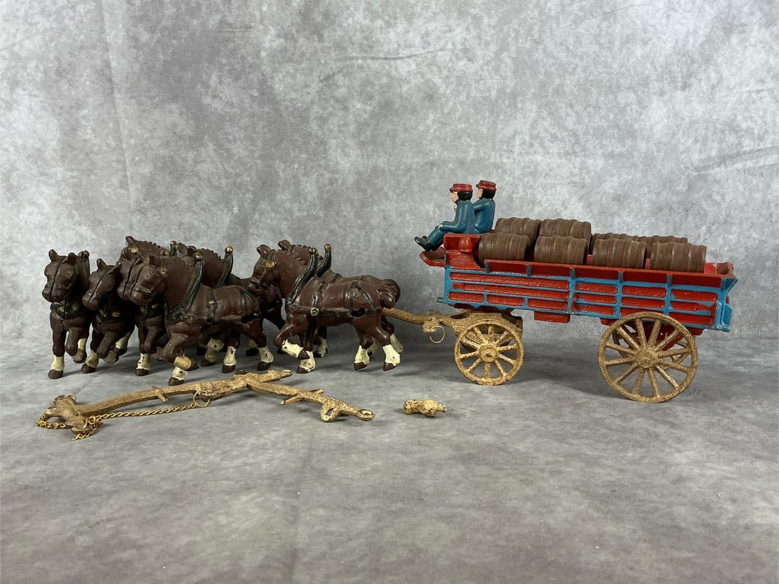Vintage Cast Iron Clydesdale Horses and Wagon Toy: Mid - 20th century cast iron vintage Clydesdale horses, wagon, two men, one dog, eight total horses, and 10 wooden beer barrels. Several yokes, several beer barrels, and reins. Wagon measures 10 inche