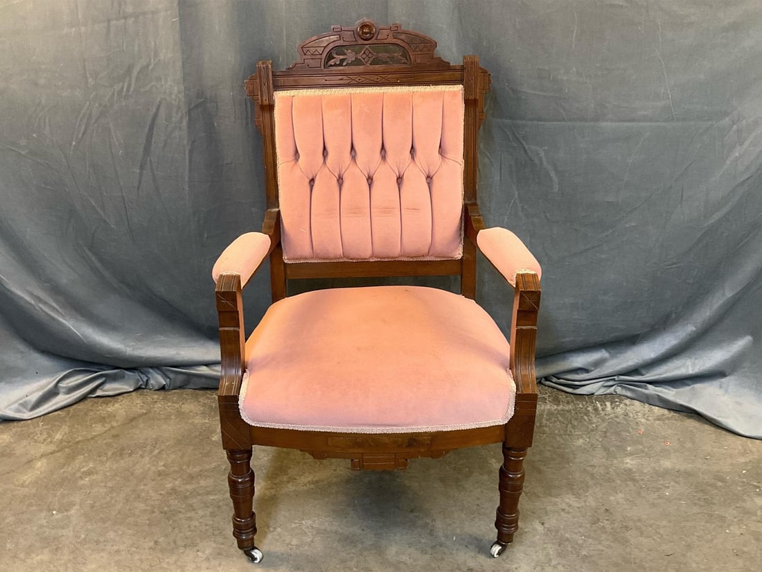 Eastlake Armchair: Late 19th century Victorian Period Eastlake upholstered armchair. Carved walnut, burled walnut crest rail and original porcelain castors. Some wear to fabric. Measures 25 inches wide x 21 x 42 inches