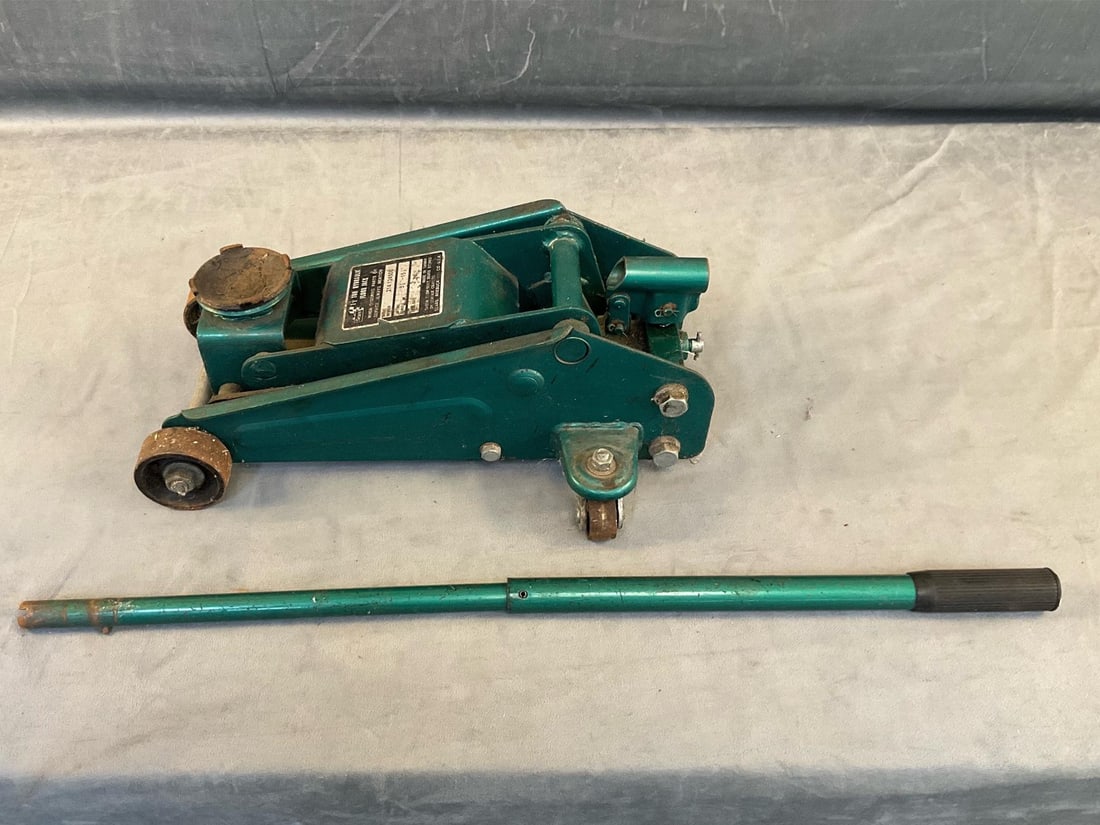 Sears Floor Jack: 1 1/2 ton hydraulic floor jack. Used, leaking hydraulic fluid. Functions correctly and in fair condition. 17 inches long X 10 inches wide. Lifting range 5 1/8 inches to 15 1/8 inches.