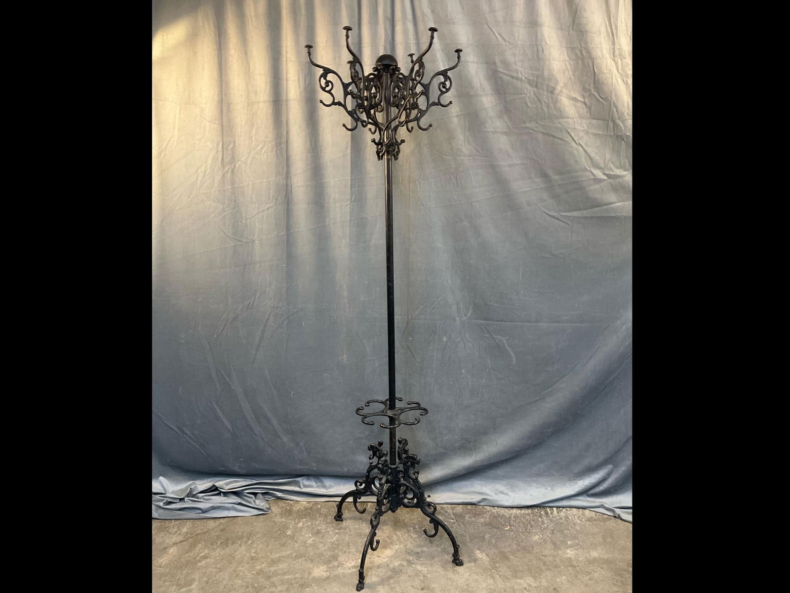 Cast Iron Coat Umbrella/Stand: Late 19th century cast iron and brass (center pole) Victorian hat and umbrella stand. Patent date marked 1904. Missing finial which hold arms in place. Loose arms. Measures 21 inches wide x 71.5 inche