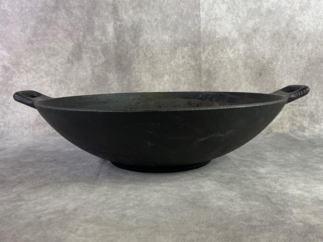 Cast Iron Wok: Joyce Chen 14 inch cast iron wok. In good condition, could be cleaned and reseasoned though. Measures 14 inches in diameter x 4 inches tall.