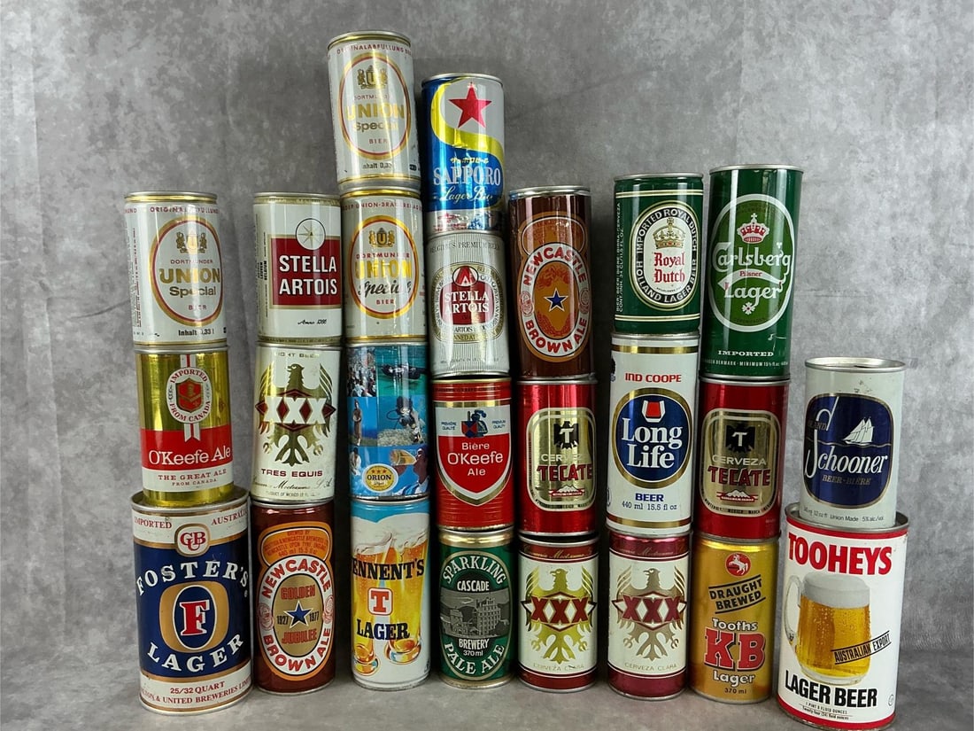 Collectible Beer Cans: An assortment of 1970's-1980's pull tab top import beer cans. Twenty seven total cans. Stella Artois, Tennent's, Foster's Lager, O'Keefe, New Castle, Tres Equis, Dortmunder Union, Toohey's, Carlsberg,