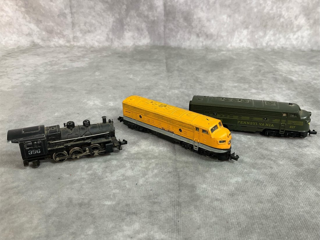 Vintage Toy Train Engines: Three mid century train engines. Steam engine 0-6-0 #386, Pennsylvania #217 engine, and a D.R.G. & W. Rio Grande Yellow engine. All in good condition. Green Pennsylvania engine measures 4 inches long