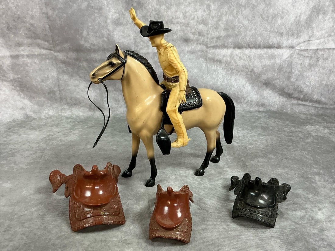 Roy Rogers, Horse & Saddles: Five mid century toys. Hard plastic Roy Rogers cowboy figure, Hartland horse, and three plastic western saddles. Cowboy is missing some fingers, has marks and worn appearance. Otherwise items in good