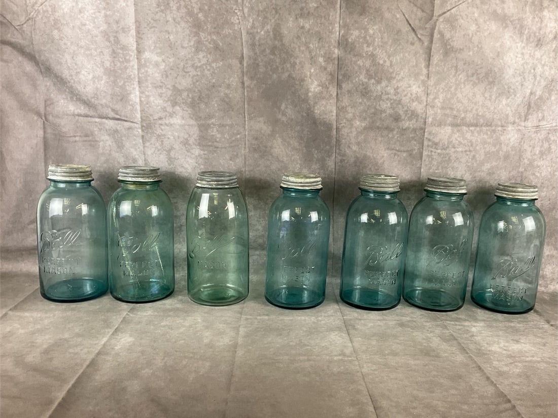 Ball Mason Jars: Seven early 20th century vintage Ball Mason canning jars. Good condition. Measures 4.5 inches in diameter x 9 inches tall.
