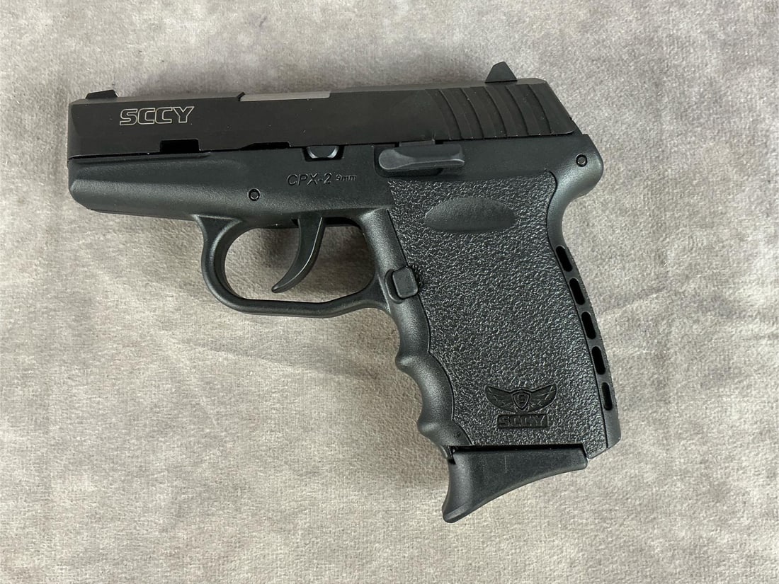 SCCY Model CPX-2 CB 9 MM Pistol: Serial 720663. Looks to be unfired and in good condition. Clean bore. Includes extra magazine, trigger lock and box. Barrel length 3 inches, overall length 6 inches