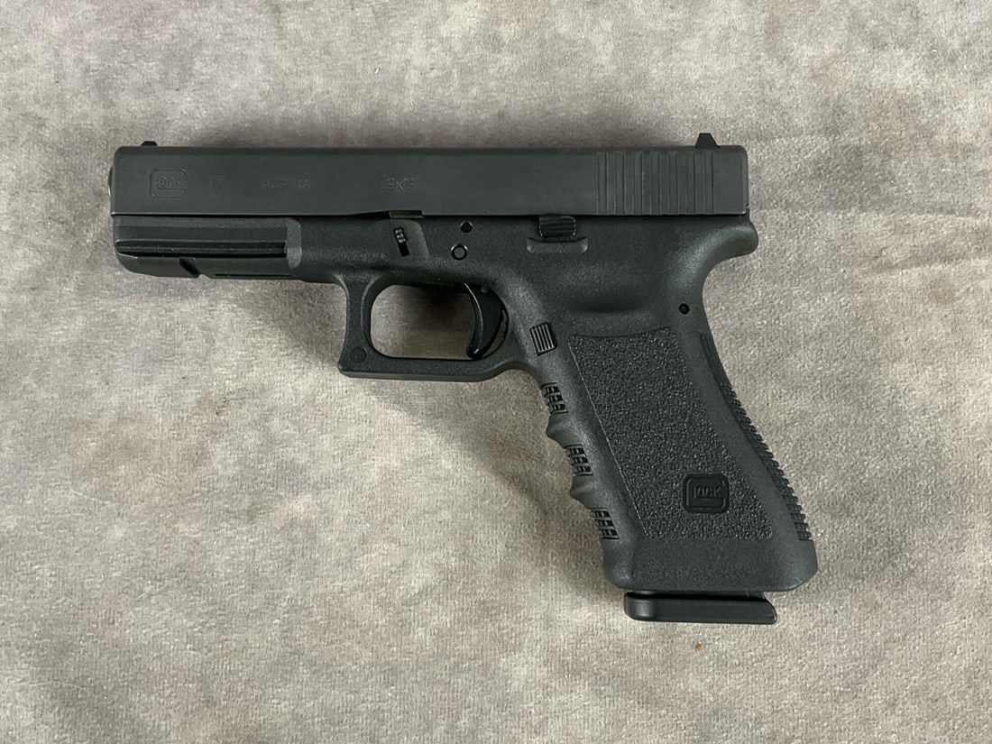 Glock G17 9 MM Pistol: Serial # BEPR103. Clean bore and in good condition. Includes hard plastic case, extra magazine, cleaning brush and jag. Barrel length 4.25 inches, overall length 7.5 inches.