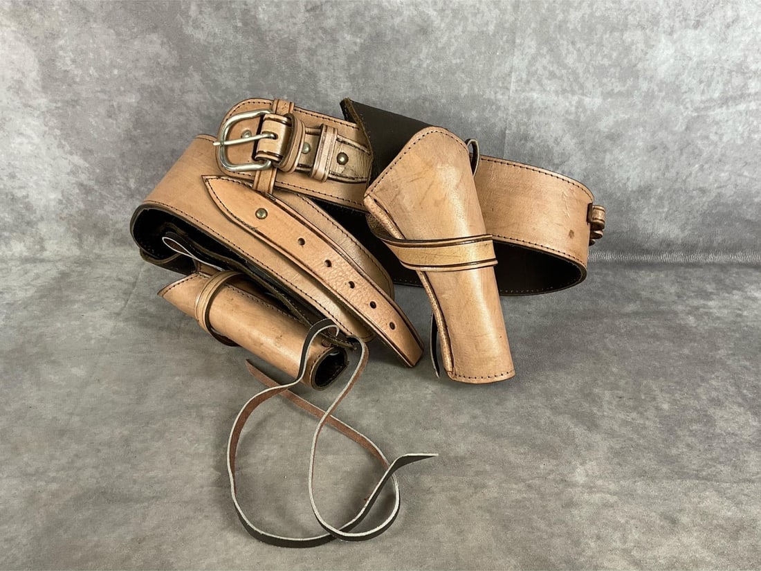 Western Gun Belt And Holsters: Leather revolver gun belt. Waist 42 inch through 45 inch . Made in Mexico.