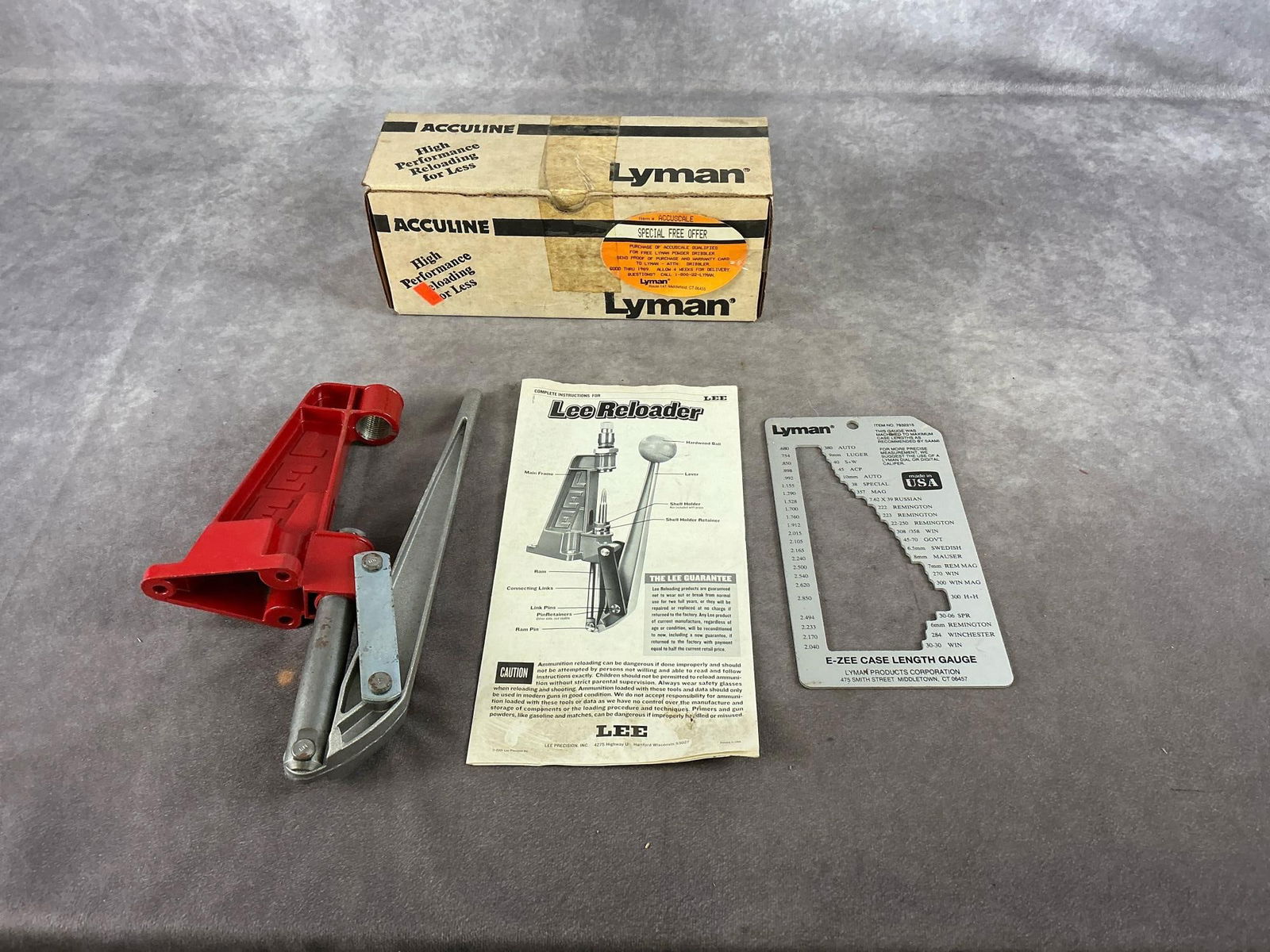 Lyman & Lee Reloading Accessories: Lyman vintage scale . Lee reloader and Lyman case length gauge. Largest item measures 11 inches long X6 inches wide X 2 inches high.