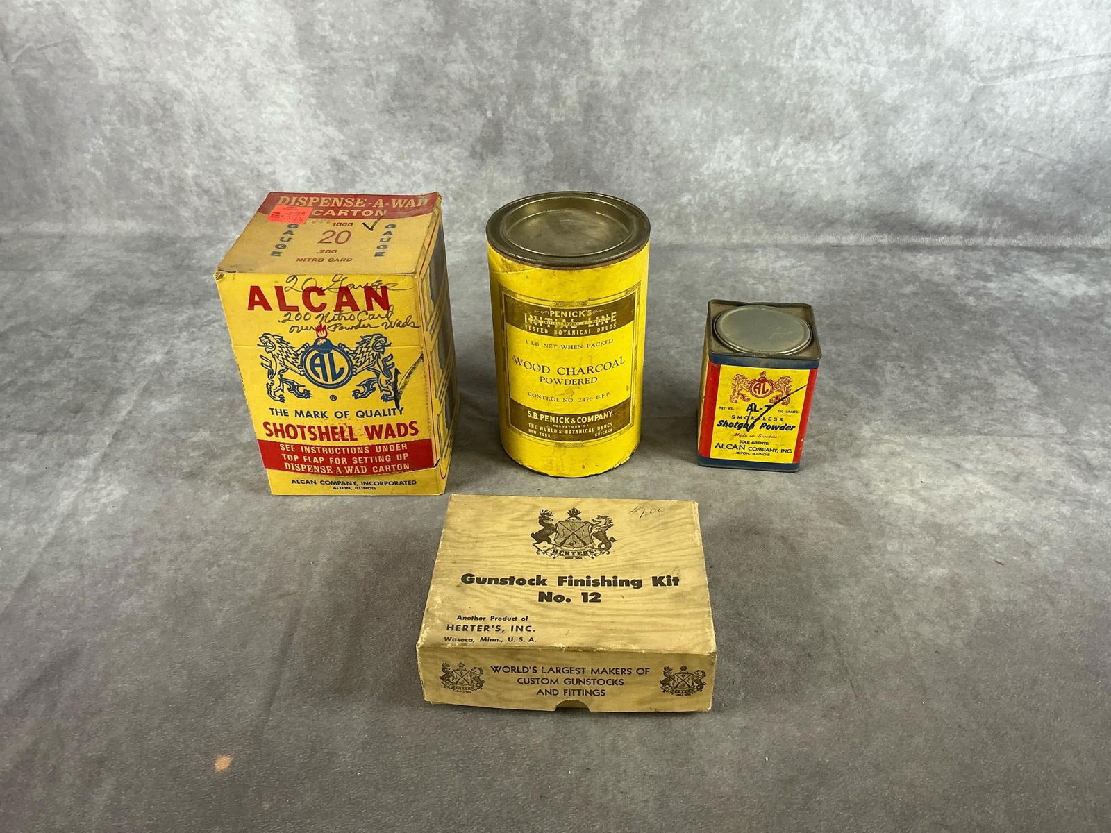 Vintage Gun Related items: 1 lot as pictured. Vintage gun powder can ( empty ), shotshell wads, wood charcoal and gunstock finishing kit. Largest item measures 5 inches long X 5 inches wide X 7 inches high.