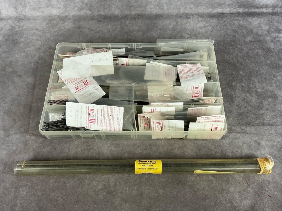 Wolf Gun Springs Brownells Spring Stock: 1 lot. Assortment of gun springs and spring stock. Container measures 14 inches long X 8.5 wide X 2 inches high.