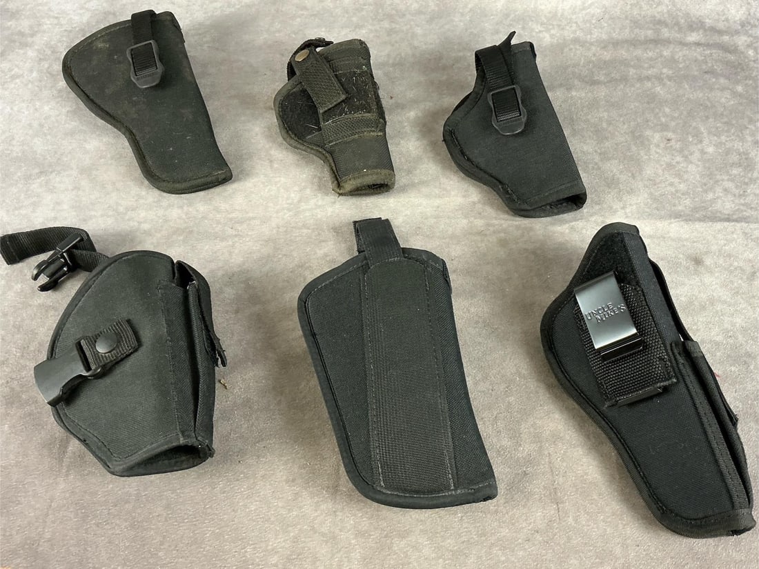 Handgun Holsters: 1 lot six items total. Uncle Mikes and Blackhawk holsters. Sizes 2,5 and 7. All used and fair to good condition. Five right hand and one left hand. Largest holster measures eight inches long X 4.5 inc