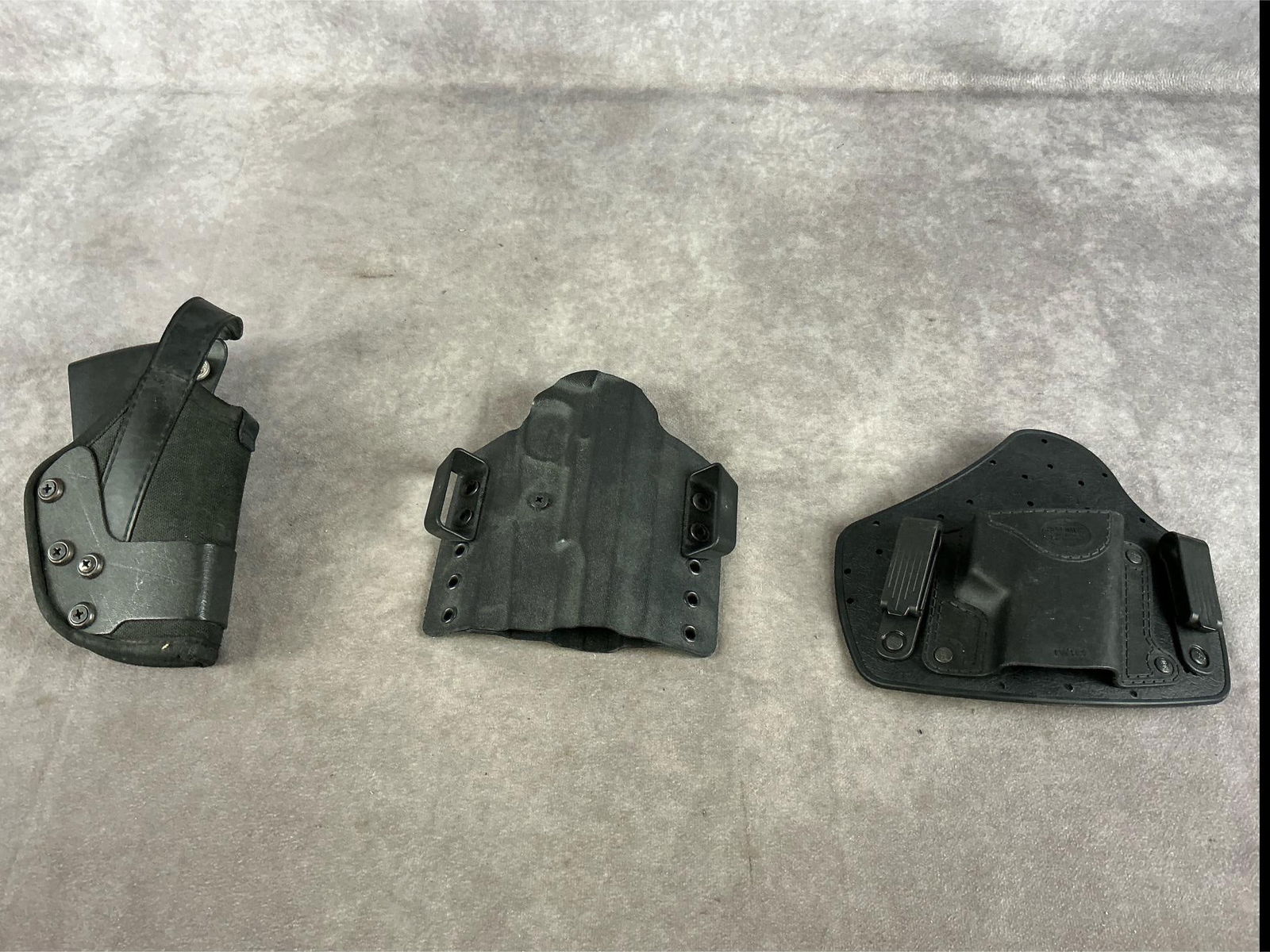 Hard Side Tactical Holsters: 1 lot three items total. Uncle Mikes retention, Kydex tactical and Fobus small pistol. All used and in good condition. Largest measures 7.5 inches long X 4.5 inches wide X 2.5 inches high.