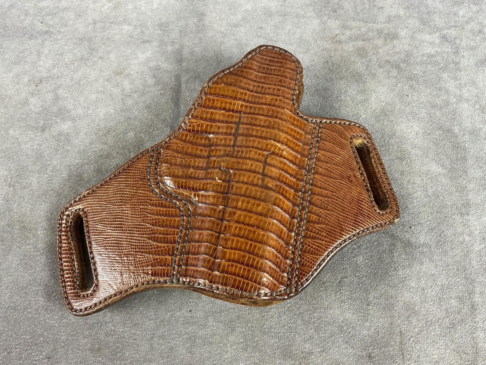 Leather Holster: Unknown maker. Has a reptile pattern stamped in the leather. Used and in good condition. Measures 8.5 inches long X 6 inches wide X 2 inches high.