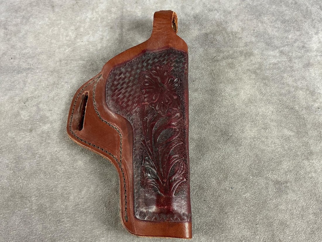 Impact Pistol Holster: Hand tooled floral pattern. Used and in fair condition. Measures 9 inches long X 5 inches wide X 1.5 inches high.