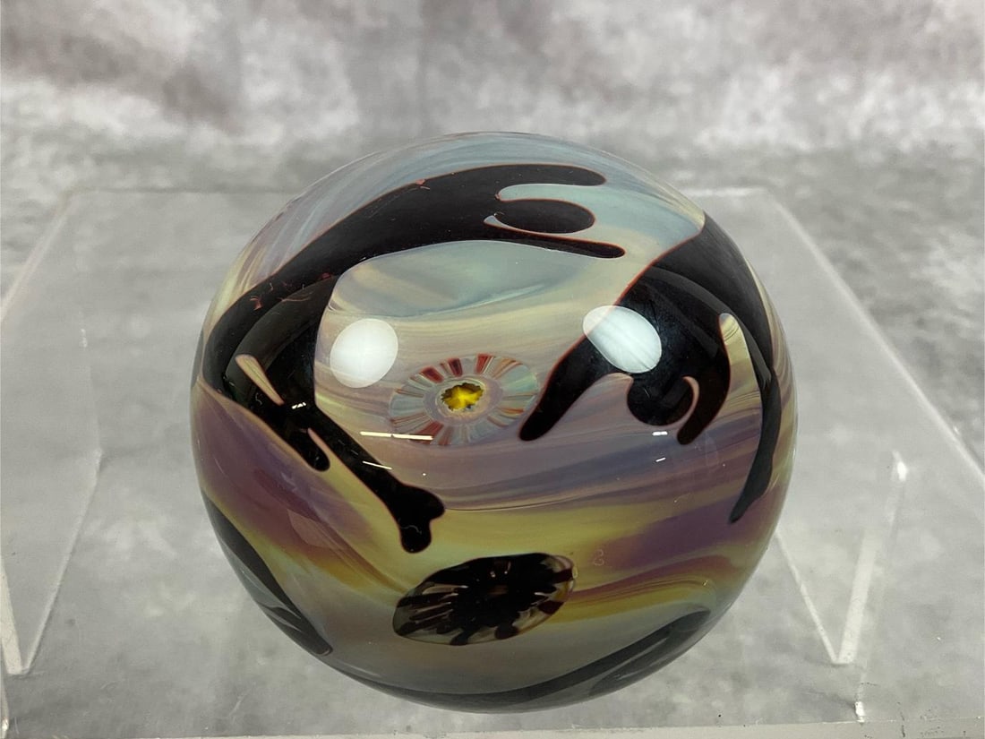 Liquid & Light Paperweight: Modern age paper weight. Art glass titled "Liquid and Light" paperweight by Elodie Holmes. Swirled colors with figures in dark brown. Good condition. Measures 3 inches in diameter x 2.25 inches tall.