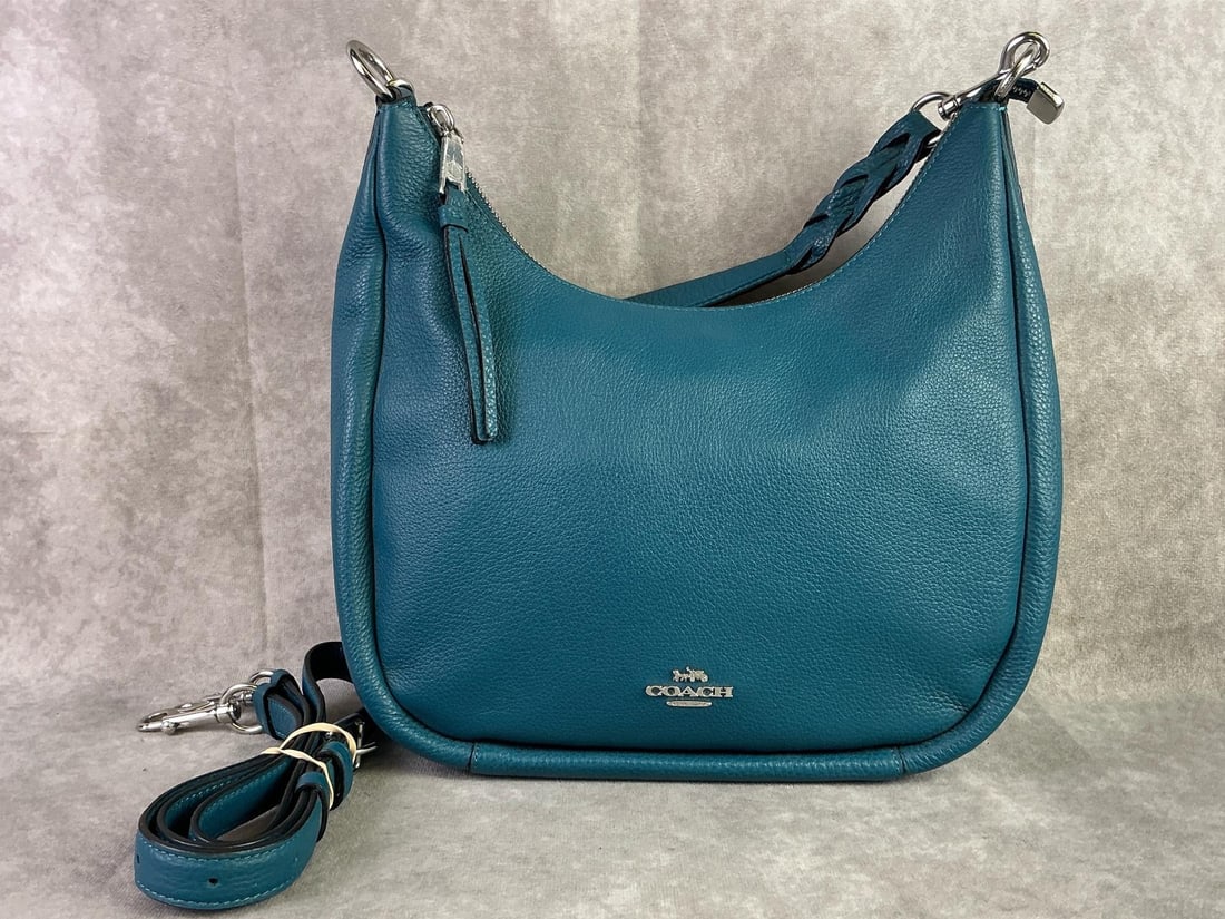 Coach Hobo Bag: Coach pebble leather Jules Hobo bag in deep turquoise. In good condition with adjustable shoulder strap. Bag measures 12.25 inches long x 11.5 inches tall x 3.5 inches wide.