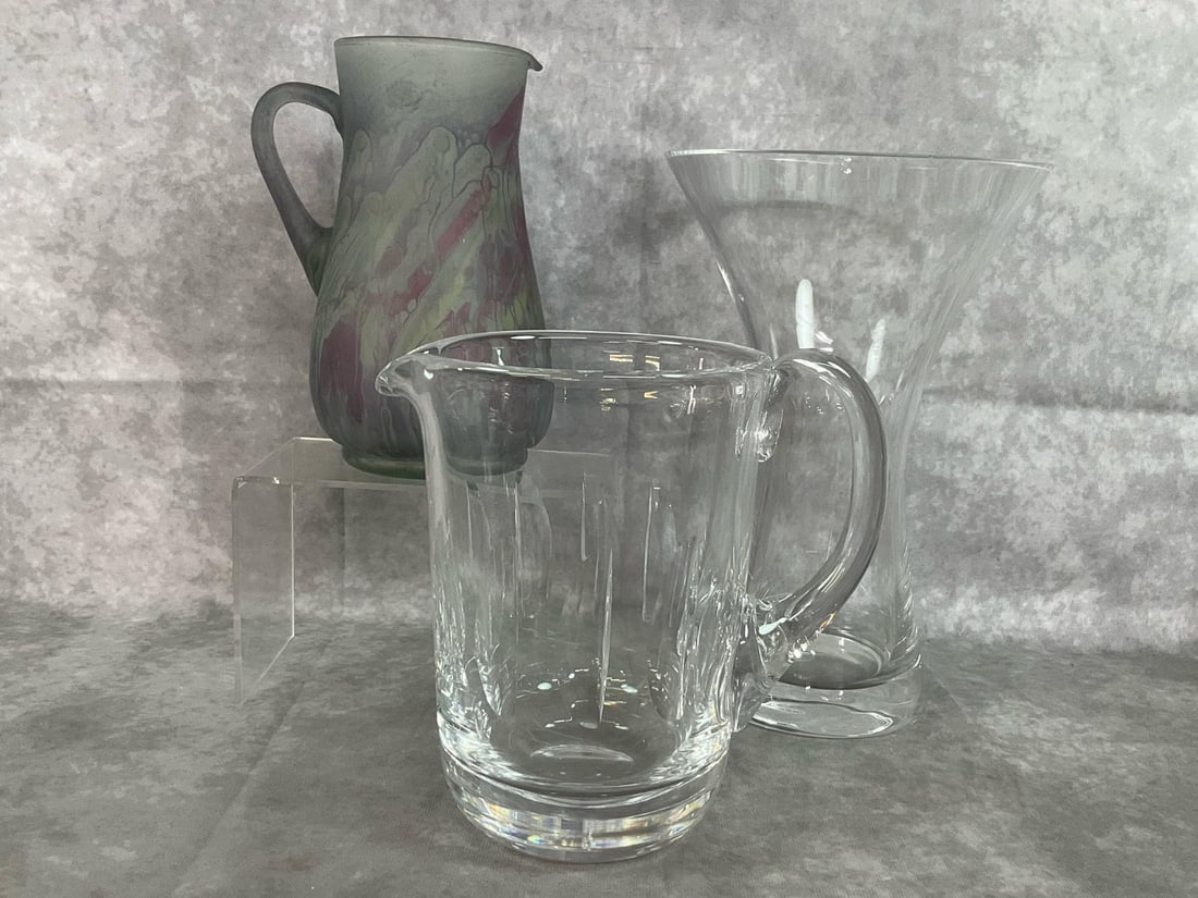 Glass Pitchers & Vase: Three vintage glass pieces. Hourglass shaped heavy clear glass vase, lead crystal Waterford pitcher, and hand painted frosted Art Nouveau Glass pitcher. All in good condition. Clear vase measures 7