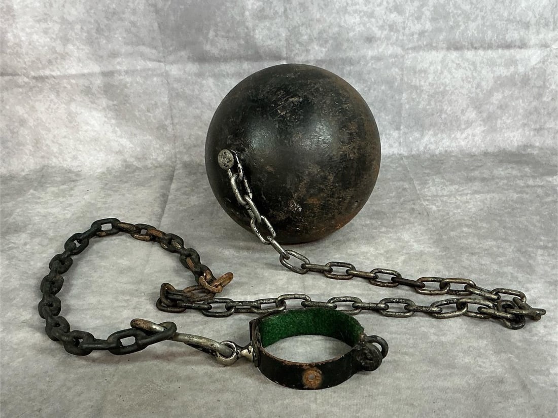 Ball and Chain: Late twentieth century handmade reproduction cast iron ball and chain. Very heavy. Wear with some surface rust. Ball measures approximately 8 inches in diameter. Chain measures approximately 56
