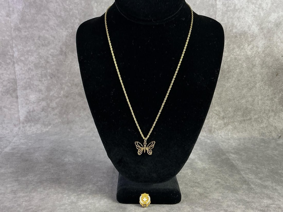 14kt Necklace & 10kt Pin: 14kt gold rope chain with butterfly pendant and 10kt gold 5 year service pin. In good condition and stamped. Total weight of 14kt is 4.9dwt and 10kt is 1.9dwt.