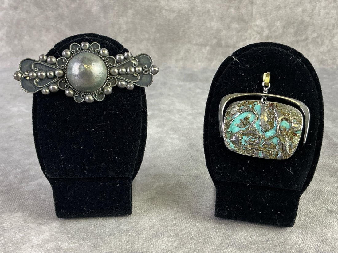 Silver Brooch & Pendant: Silver brooch stamped 900 and silver pendant featuring turquoise coloring to design. Both in good condition and pendant scratched tested. Total weight 0.99ozt.