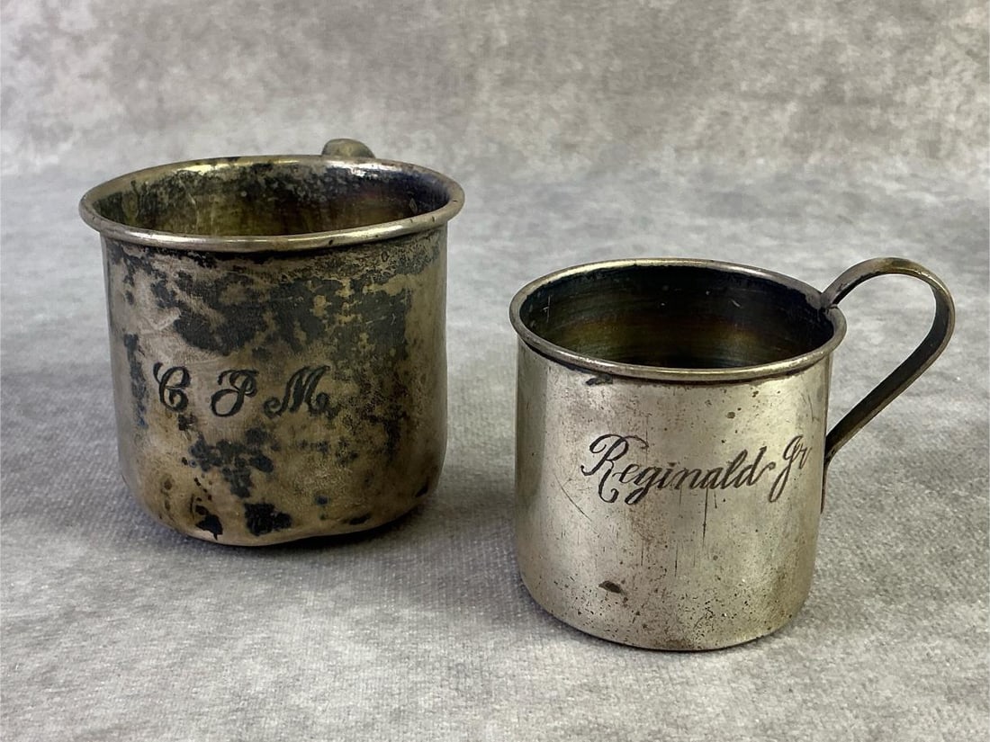 Sterling Silver Cups: Two sterling silver children's cups. Both in good condition, stamped with oxidation present. Total weight 3.93ozt.